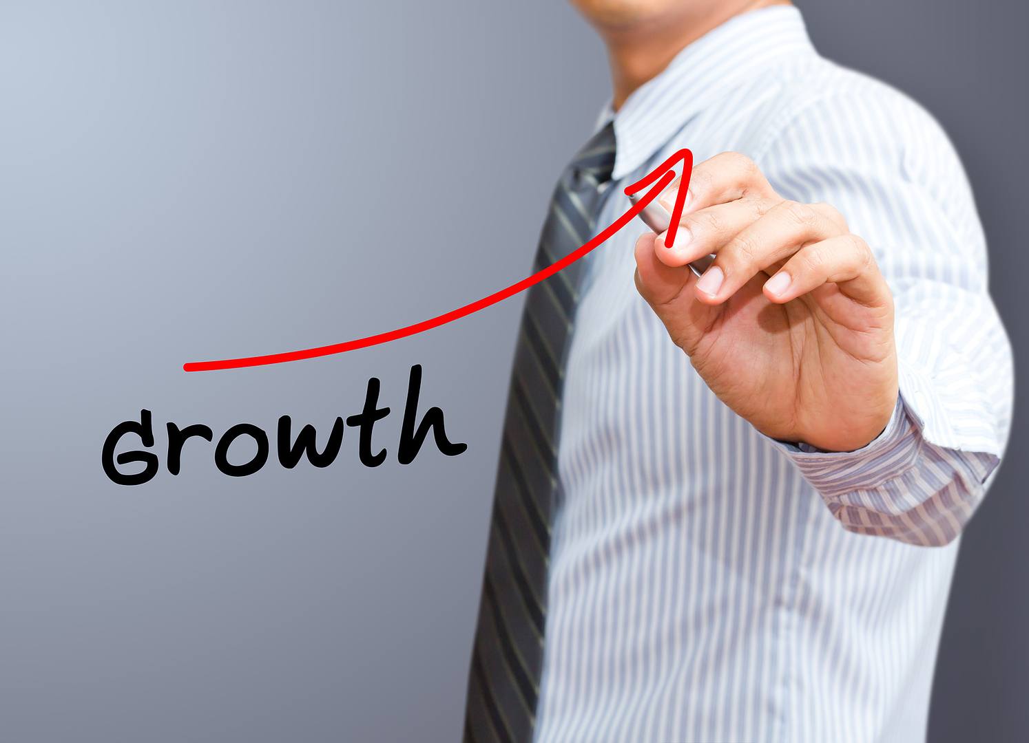 Businessman drawing a growth diagram