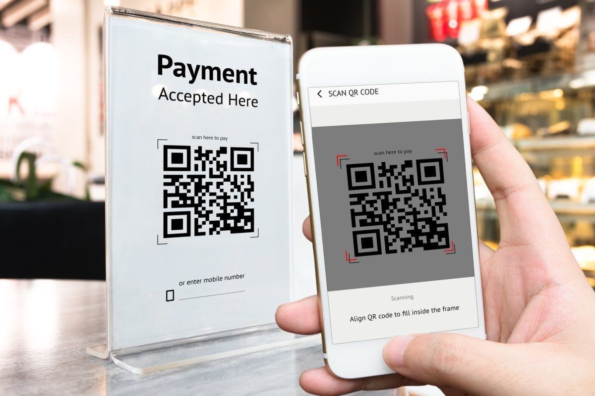 mobile phone scanning QR sign with QR bar code